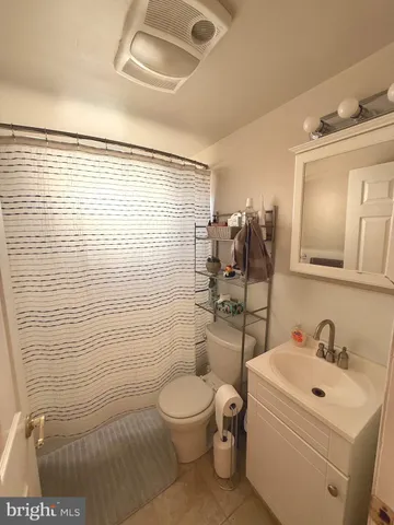 a bathroom with a toilet sink and shower