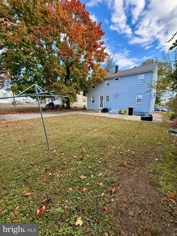 a view of a dry yard with trees