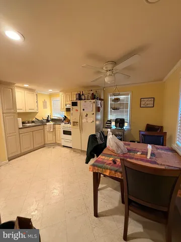 a reading room with furniture a flat screen tv and a table