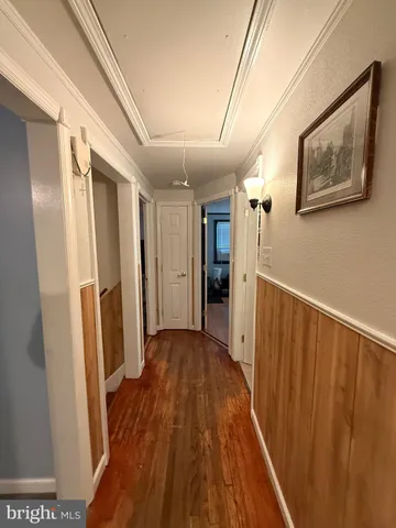 a view of hallway with wooden floor