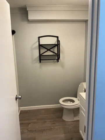 a white toilet sitting next to a shower