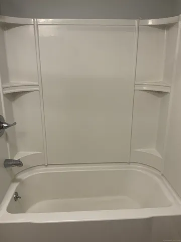 a bathroom with a shower and a bath tub