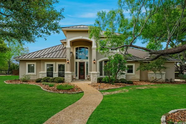 a front view of a house with garden