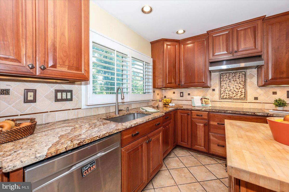 10 Megans Court Olney, MD 20832 - Photo 14 of 47 a kitchen with granite countertop a sink stainless steel appliances and cabinets
