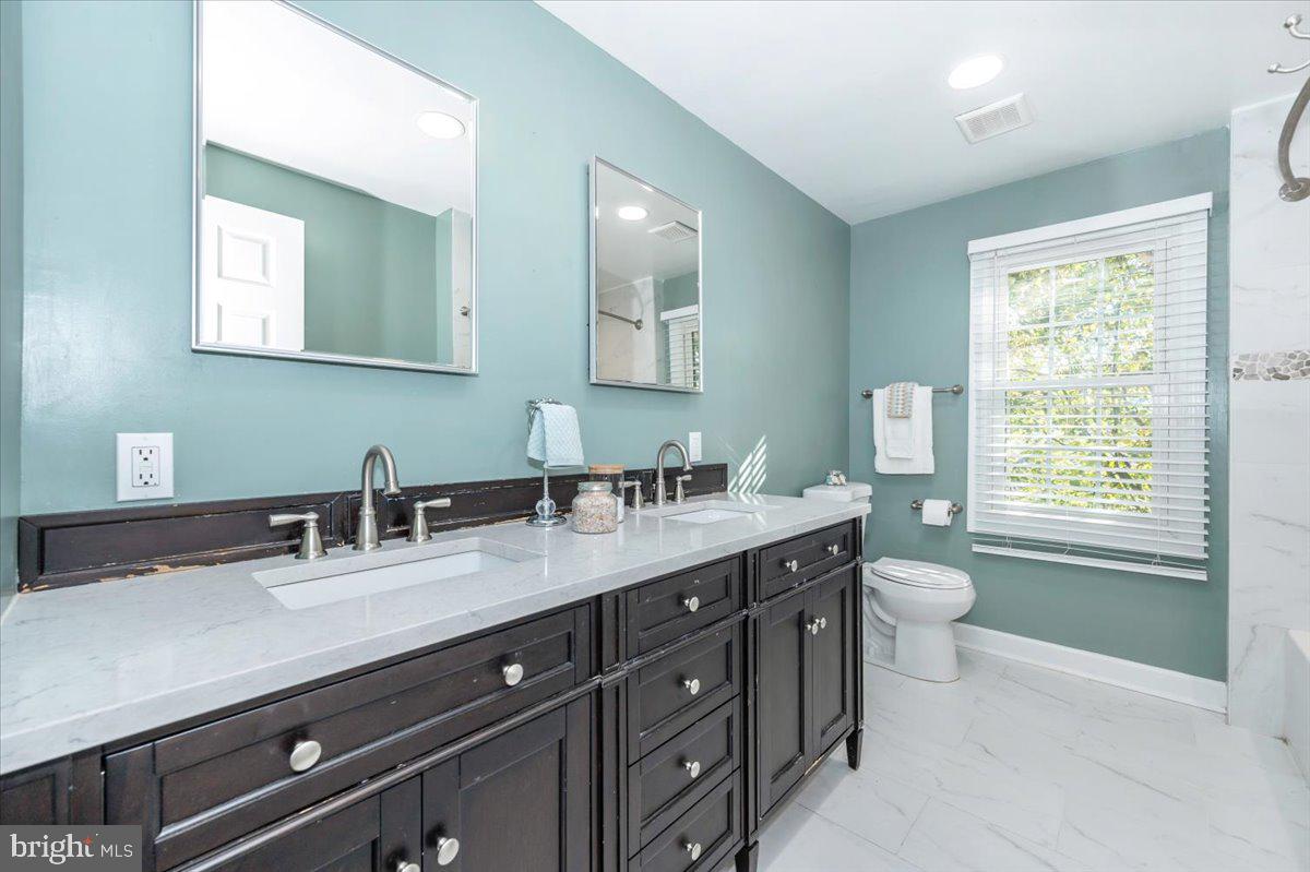 10 Megans Court Olney, MD 20832 - Photo 27 of 47 a bathroom with a granite countertop sink a toilet and a mirror