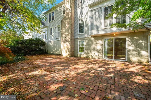 a view of a brick house with a large windows and plants
