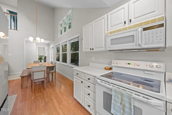 a kitchen with stainless steel appliances granite countertop a stove and a wooden floors