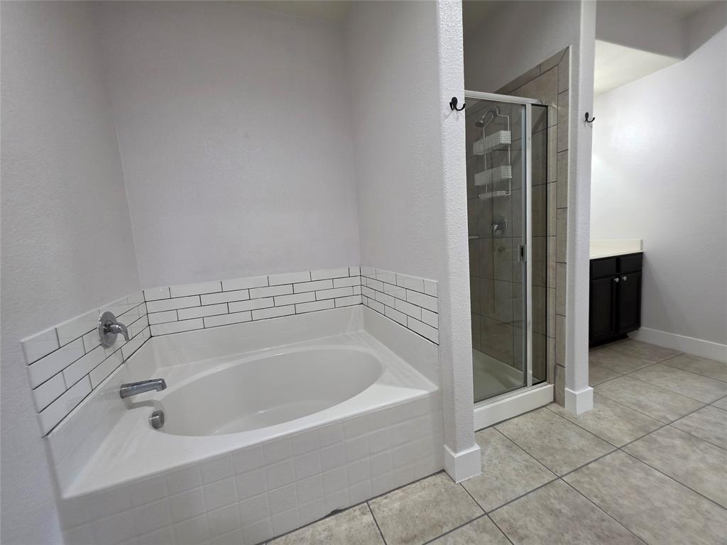 149 Ryan Street Anna, TX 75409 - Photo 19 of 38 a spacious bathroom with a bathtub
