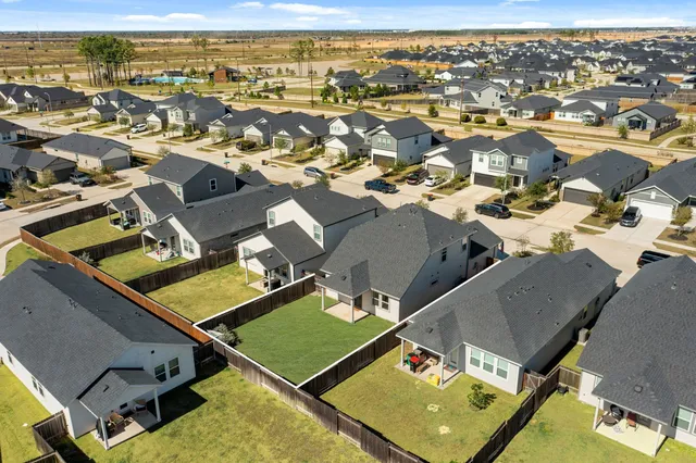 an aerial view of residential houses with outdoor space