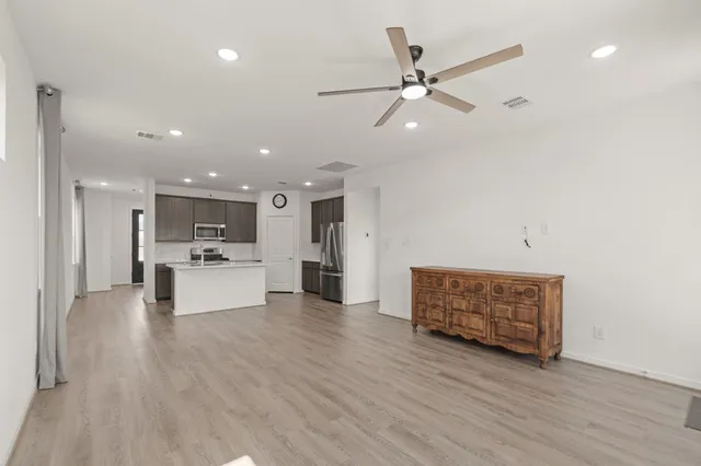 a living room with furniture and kitchen view