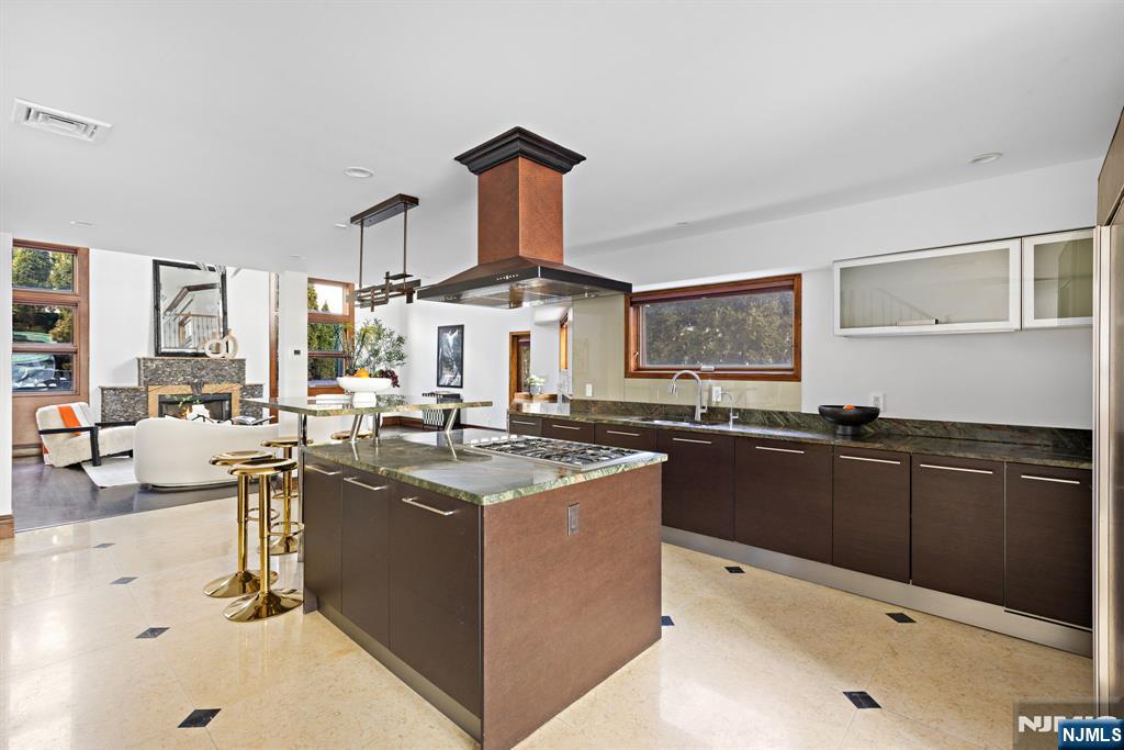 1286 River Road Edgewater, NJ 07020 - Photo 4 of 19 a kitchen with stainless steel appliances granite countertop a sink stove and cabinets