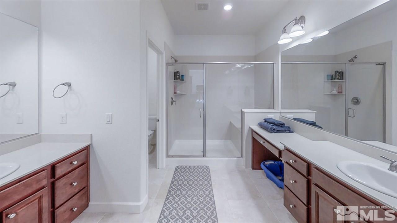 9715 Pachuca Drive Reno, NV 89521 - Photo 8 of 10 a room with a bed and a dresser