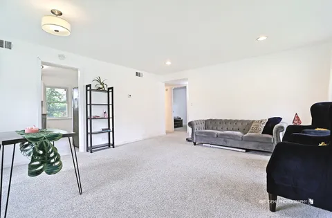 a living room with furniture and a potted plant