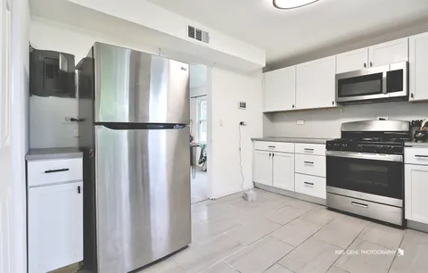 a kitchen with stainless steel appliances a refrigerator stove and microwave
