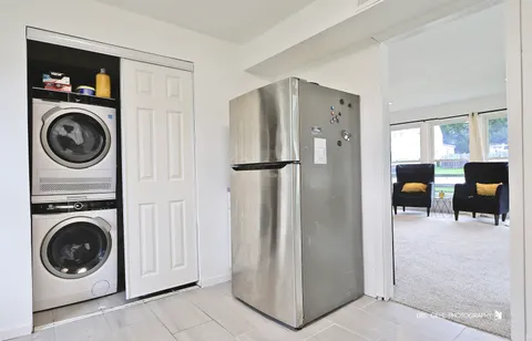 a view of a refrigerator and washer in a room