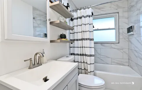a bathroom with a sink toilet and shower