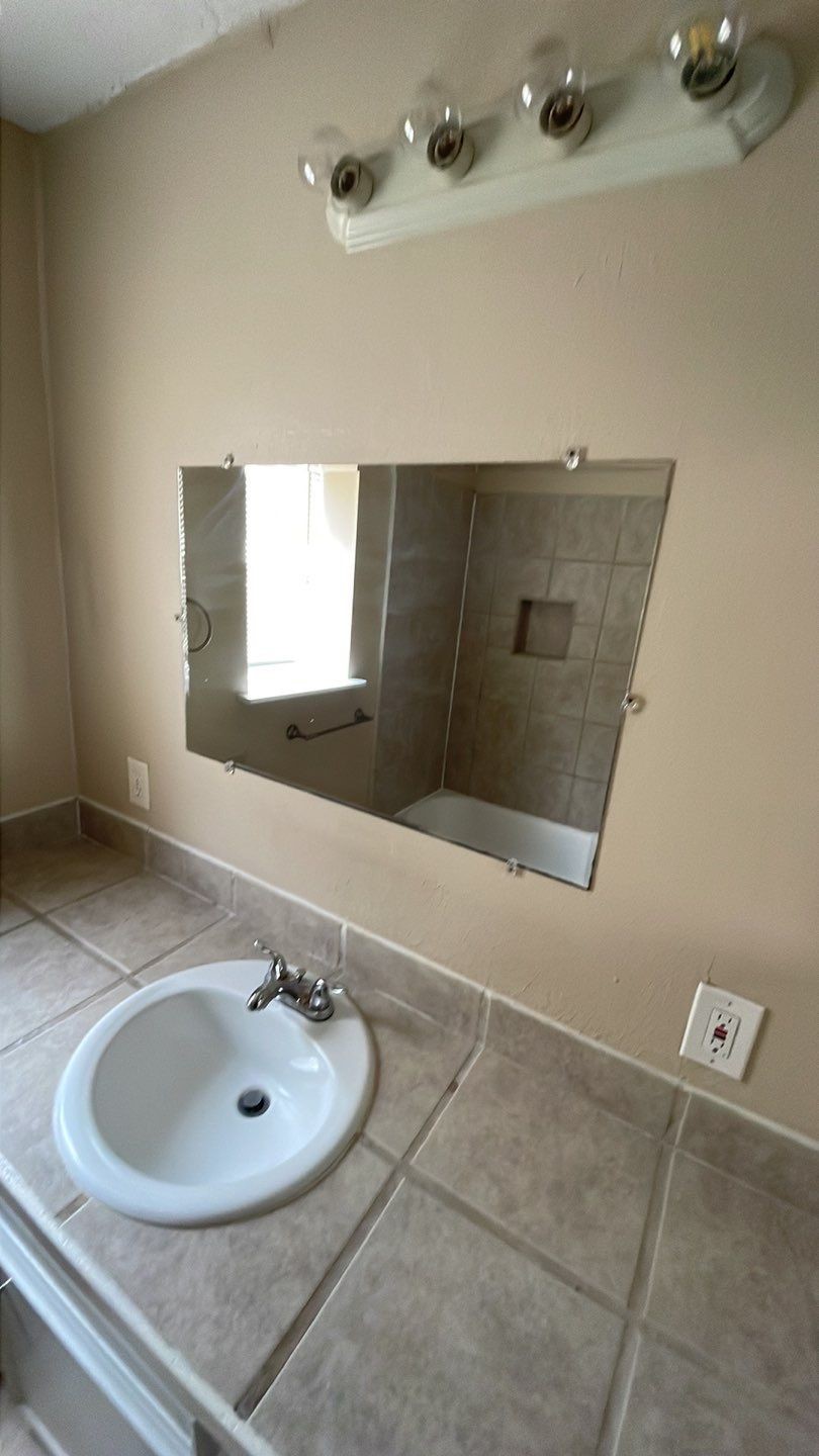 1305 Adams Street, Unit 4 Conroe, TX 77301 - Photo 11 of 32 a bathroom with a sink and a mirror