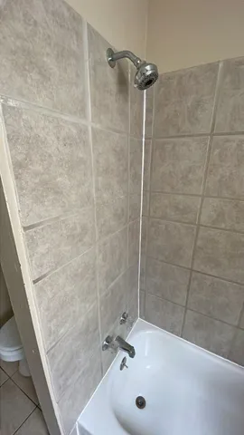 a bathroom with a granite countertop shower and a sink