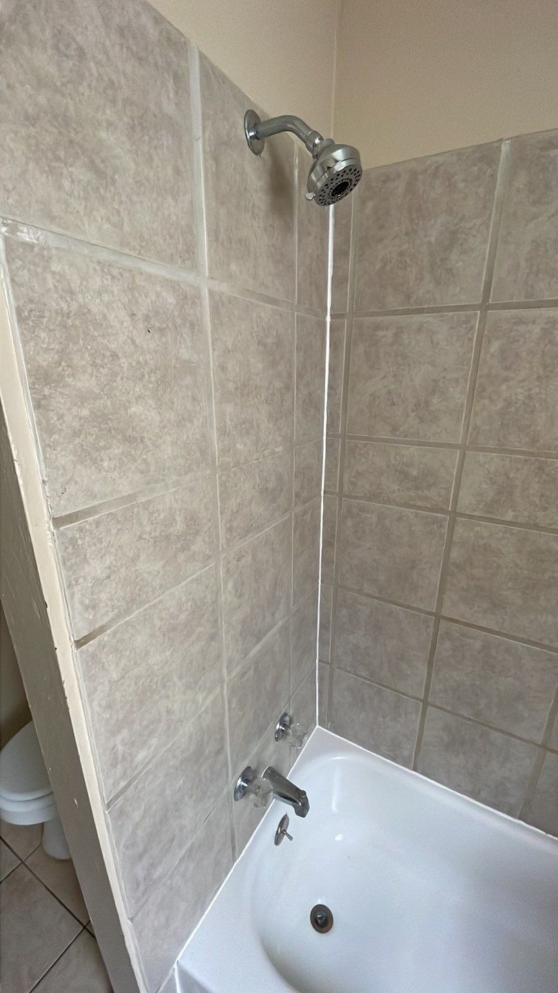 1305 Adams Street, Unit 4 Conroe, TX 77301 - Photo 14 of 32 a bathroom with a sink and a shower