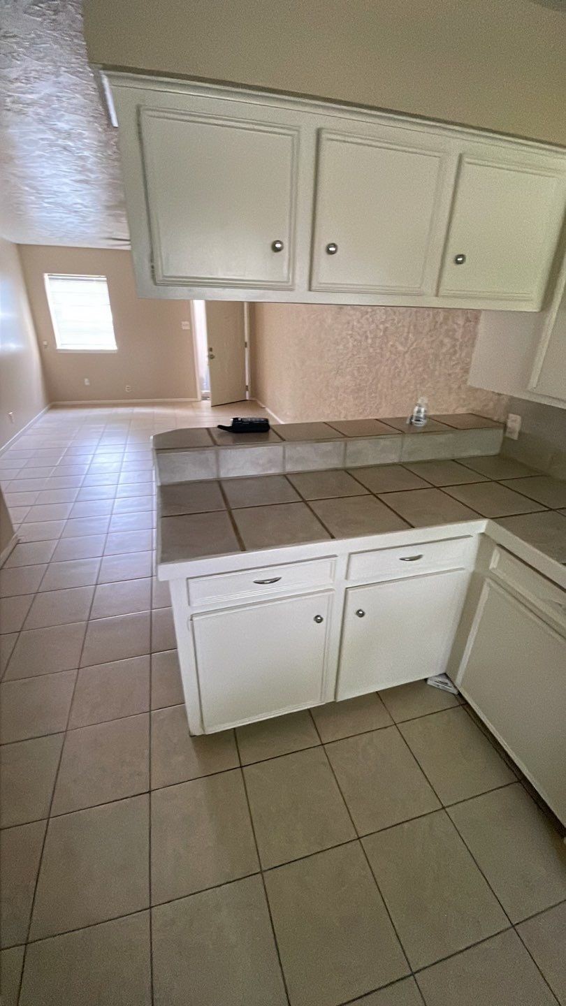 1305 Adams Street, Unit 4 Conroe, TX 77301 - Photo 23 of 32 a kitchen with a white checkered floor