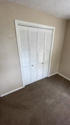 a view of an empty room with a wooden door