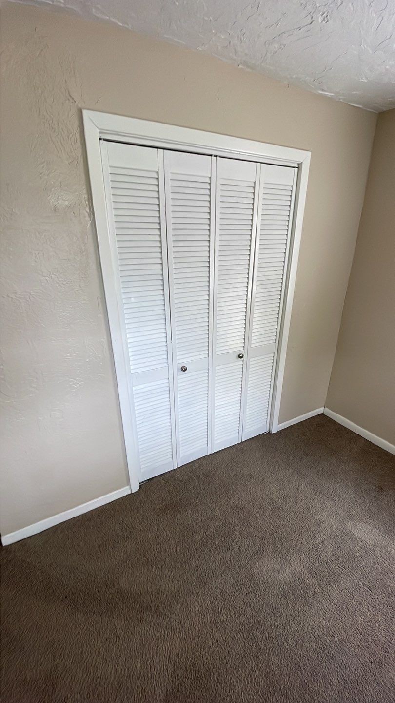 1305 Adams Street, Unit 4 Conroe, TX 77301 - Photo 5 of 32 a view of an empty room with a wooden door