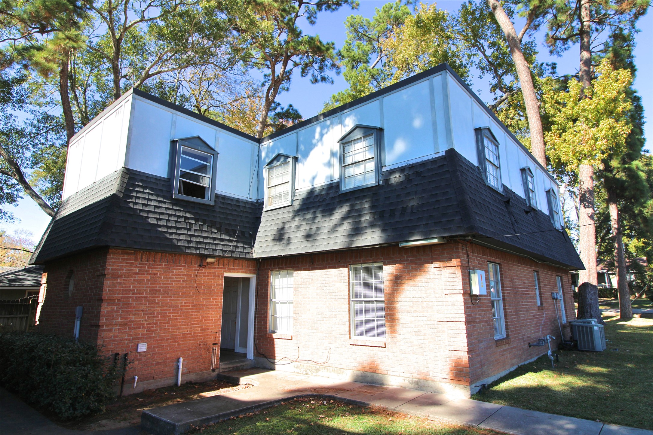 1305 Adams Street, Unit 4 Conroe, TX 77301 - Photo 9 of 13 a view of a house with a yard