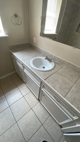 a bathroom with a sink and a mirror