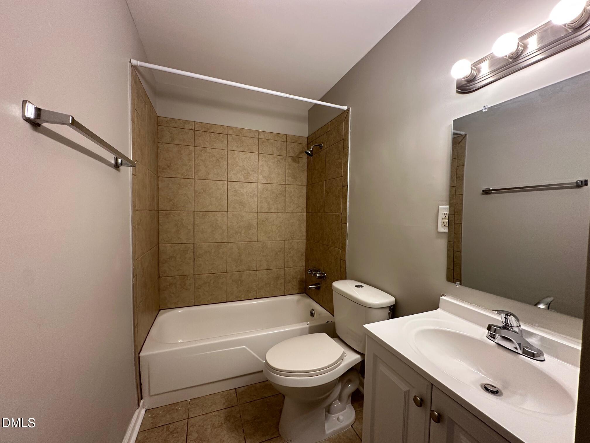 1304 Seabrook Road Raleigh, NC 27610 - Photo 12 of 19 a bathroom with a sink a toilet and shower