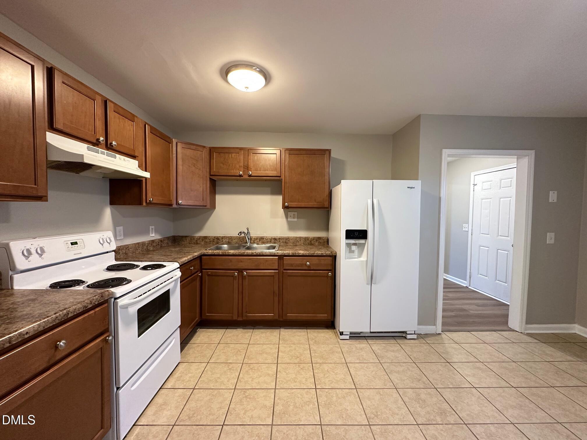 1304 Seabrook Road Raleigh, NC 27610 - Photo 6 of 19 a kitchen with stainless steel appliances granite countertop a stove a refrigerator and a sink