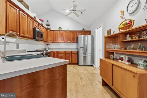 a kitchen with stainless steel appliances granite countertop a stove microwave and refrigerator