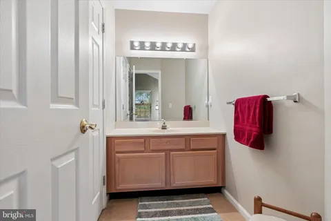 a bathroom with a sink a toilet and mirror