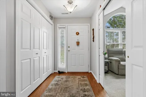 a living room with furniture a table and a large window
