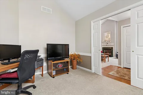 a living room with furniture a fireplace and a chandelier