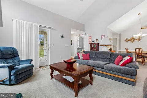 a view of a dining room with furniture and chandelier