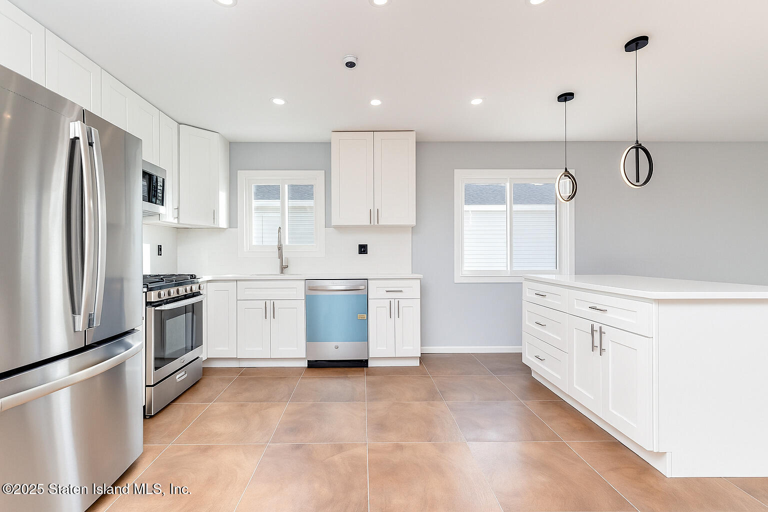 281 Arlene Street Staten Island, NY 10314 - Photo 13 of 42 a kitchen with white cabinets and stainless steel appliances