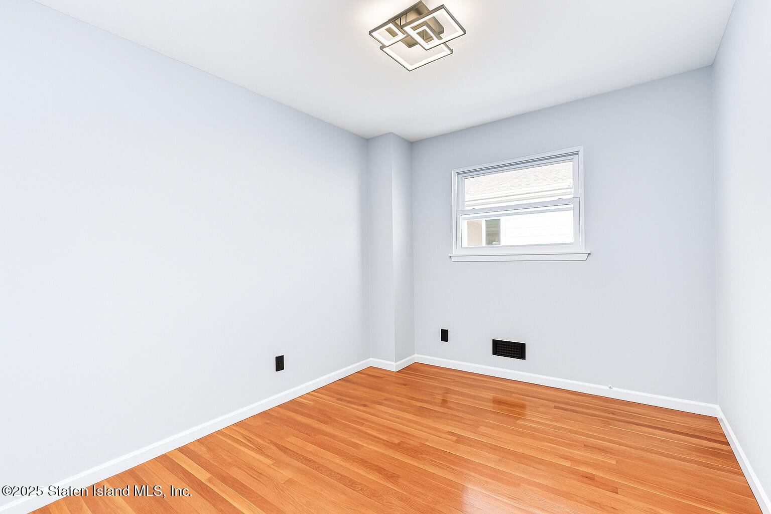 281 Arlene Street Staten Island, NY 10314 - Photo 22 of 42 a view of a room with a wooden floor and a window