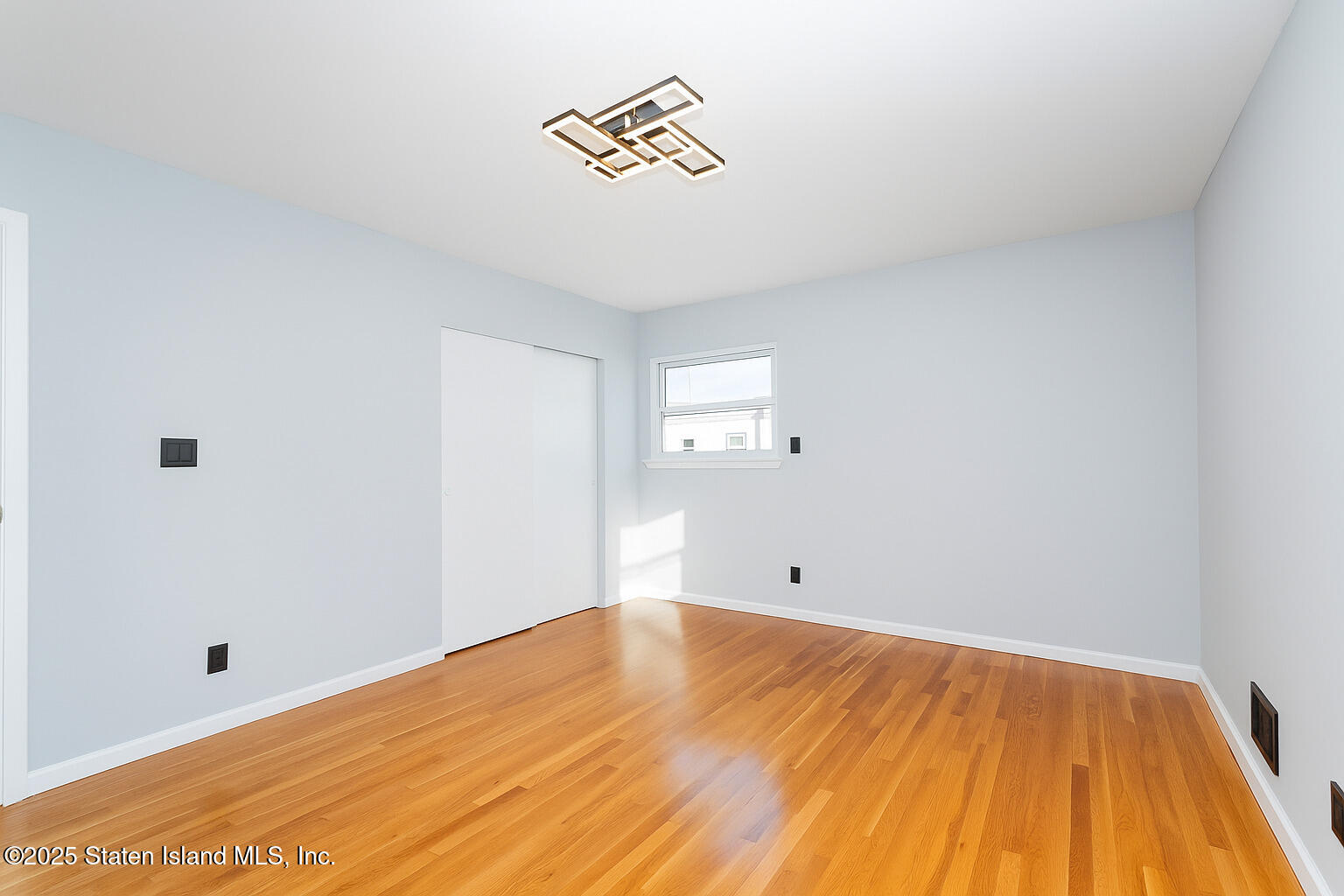 281 Arlene Street Staten Island, NY 10314 - Photo 25 of 42 a view of empty room with wooden floor