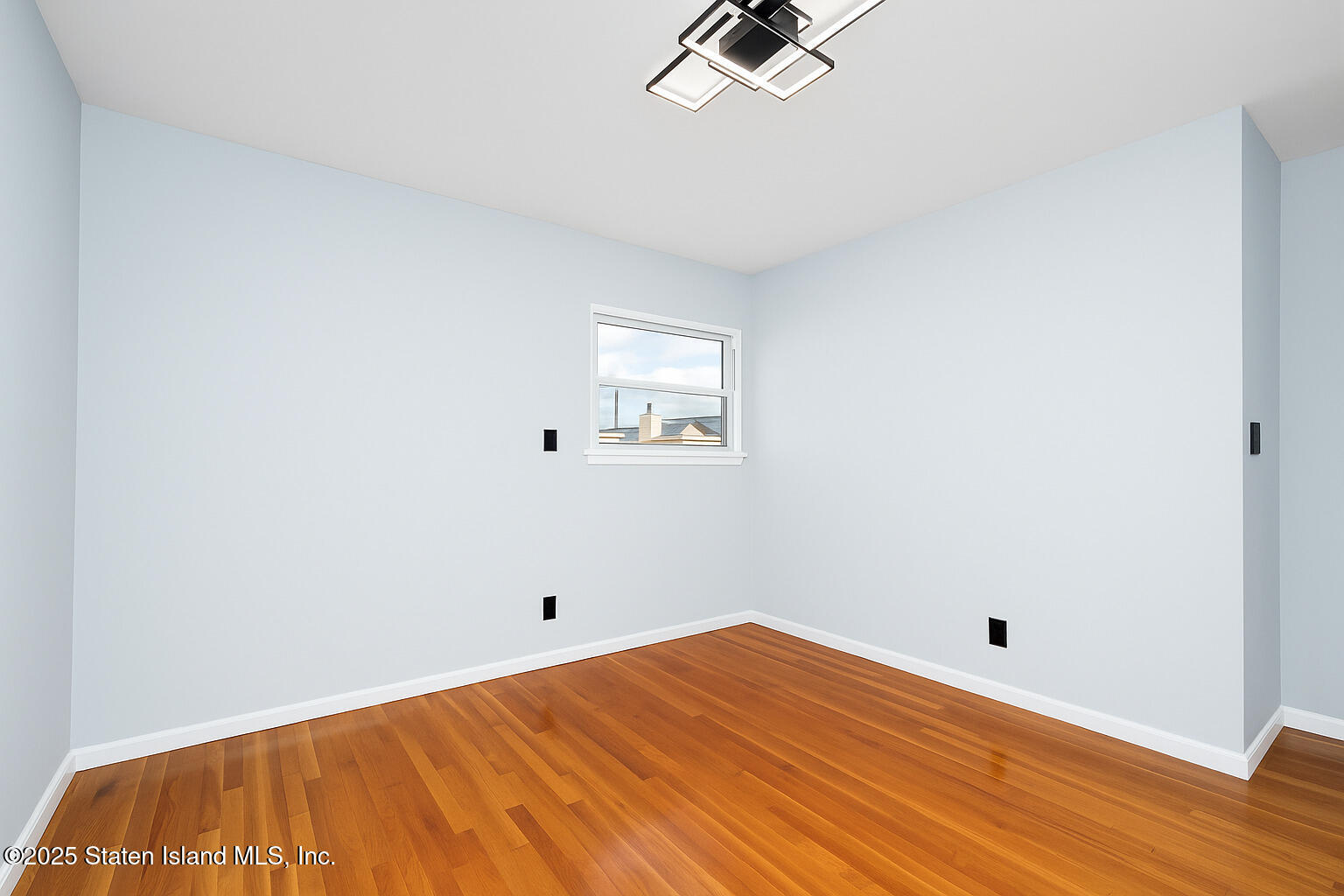 281 Arlene Street Staten Island, NY 10314 - Photo 27 of 42 a view of a room with a wooden floor and white walls