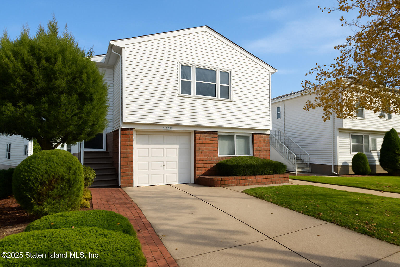 281 Arlene Street Staten Island, NY 10314 - Photo 3 of 42 a front view of a house with a yard and garage
