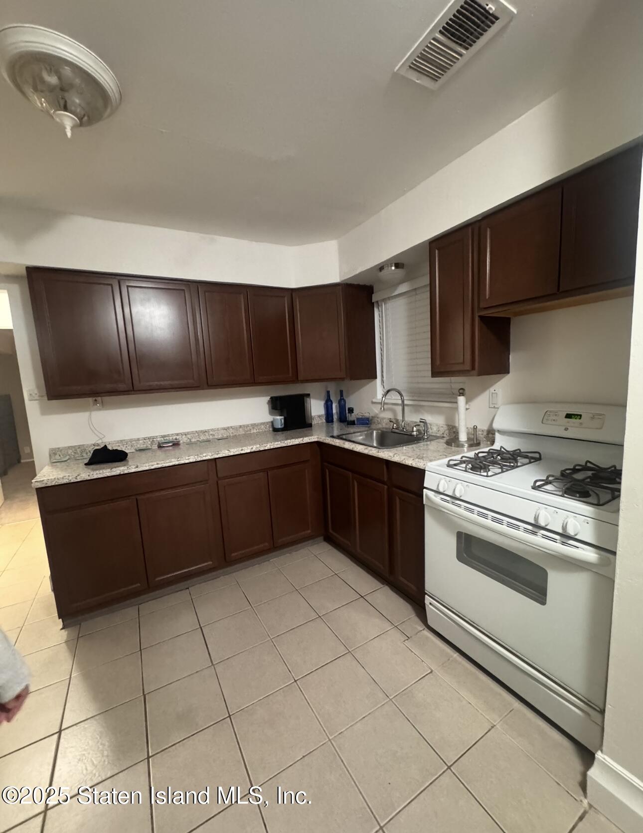 281 Arlene Street Staten Island, NY 10314 - Photo 41 of 42 a kitchen with stainless steel appliances granite countertop a sink stove and cabinets