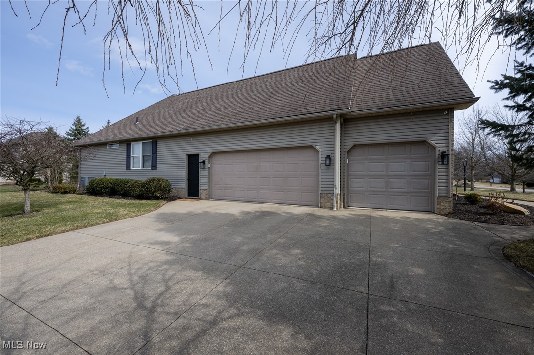 847 Lockwood Road Barberton, OH 44203 - Photo 5 of 29 Ranch-style home with a front yard, an attached garage, driveway, and roof with shingles