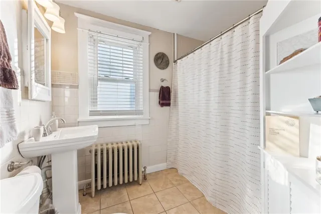 a bathroom with a sink a mirror and a shower