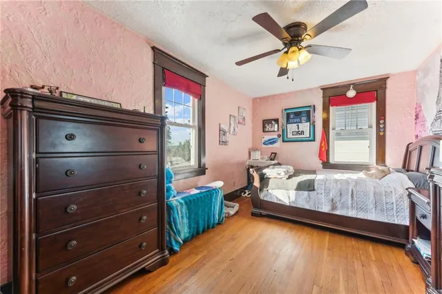a bedroom with a bed window and a dresser
