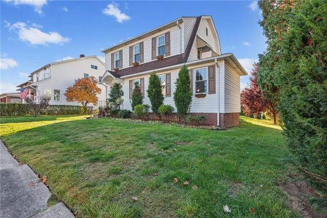 a front view of house with yard and green space