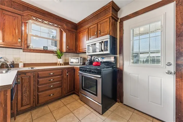 a kitchen with granite countertop a stove cabinets and a sink