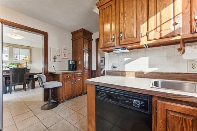 a kitchen with a sink and a stove top oven