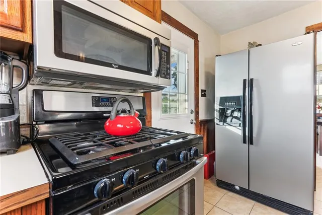 a stove top oven sitting inside of a kitchen