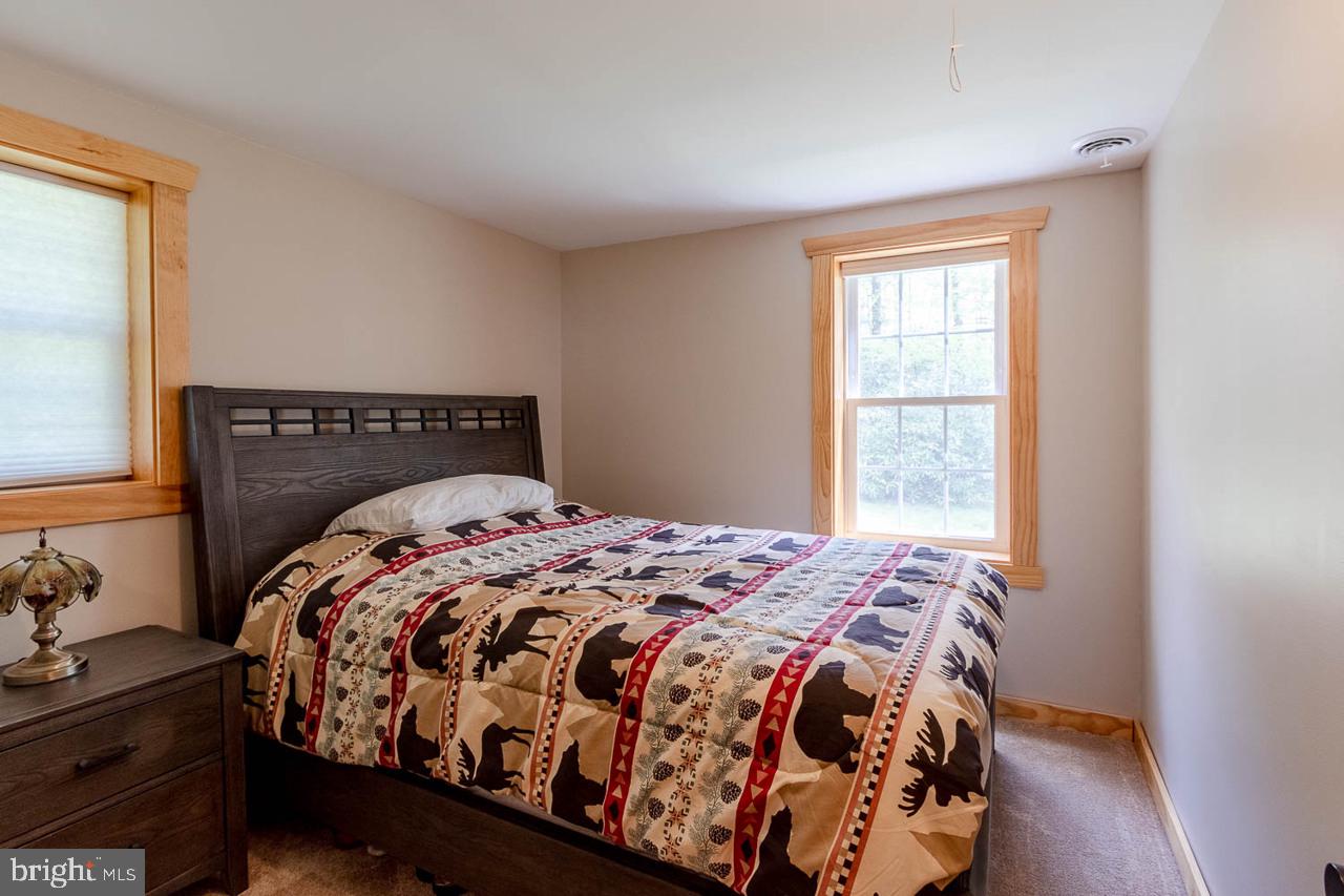 556 Treaster Kettle Road Centre Hall, PA 16828 - Photo 29 of 32 a bedroom with a bed next to a window