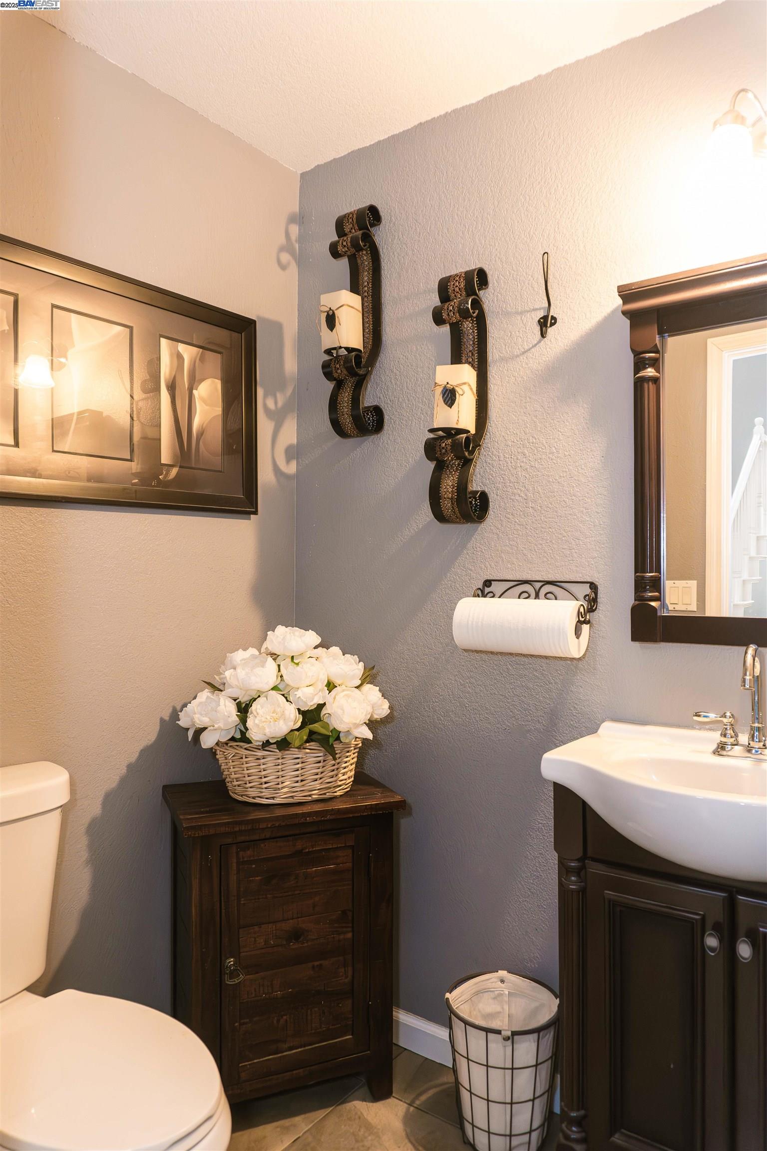 7064 Alder Creek Road Vallejo, CA 94591 - Photo 3 of 14 a bathroom with a sink mirror and toilet